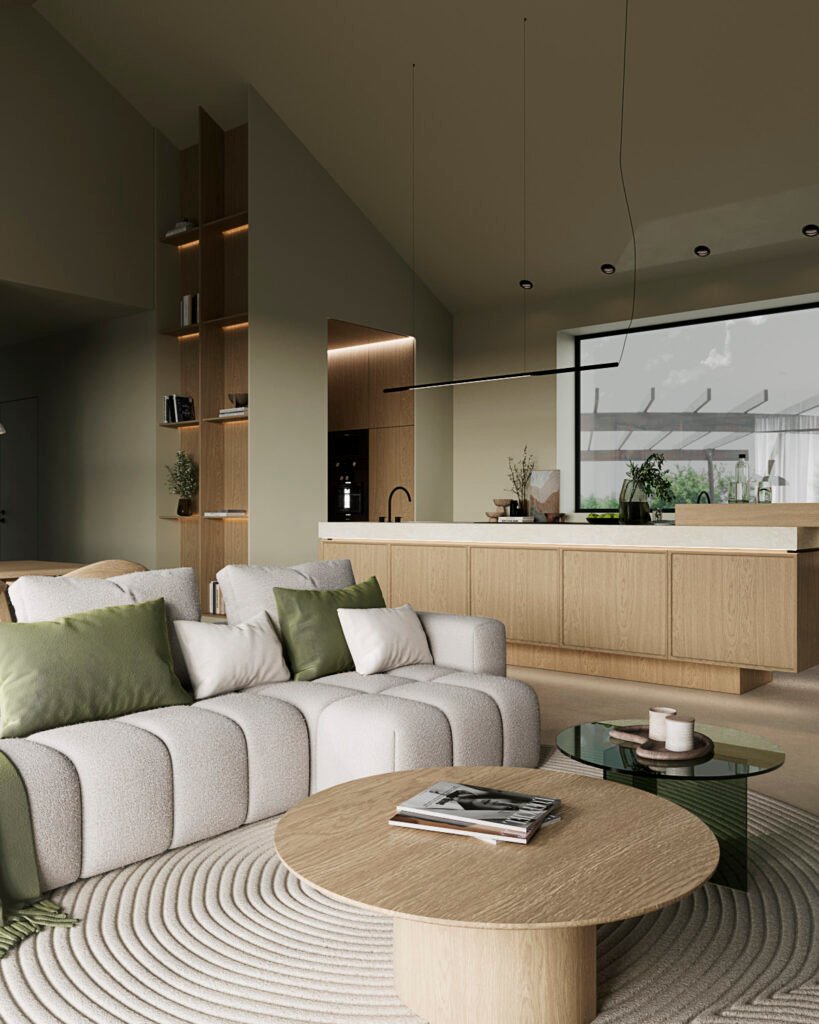 Stiligt - Modernt vardagsrum och kök med neutrala toner, en ljusgrå soffa med gröna kuddar, ett runt soffbord i trä och minimalistisk inredning. Stort fönster ger utsikt över utomhusmiljön. Köket som hjärtat i hemmet - Mer än bara en plats för mat: Skapa gemenskap och värme! 