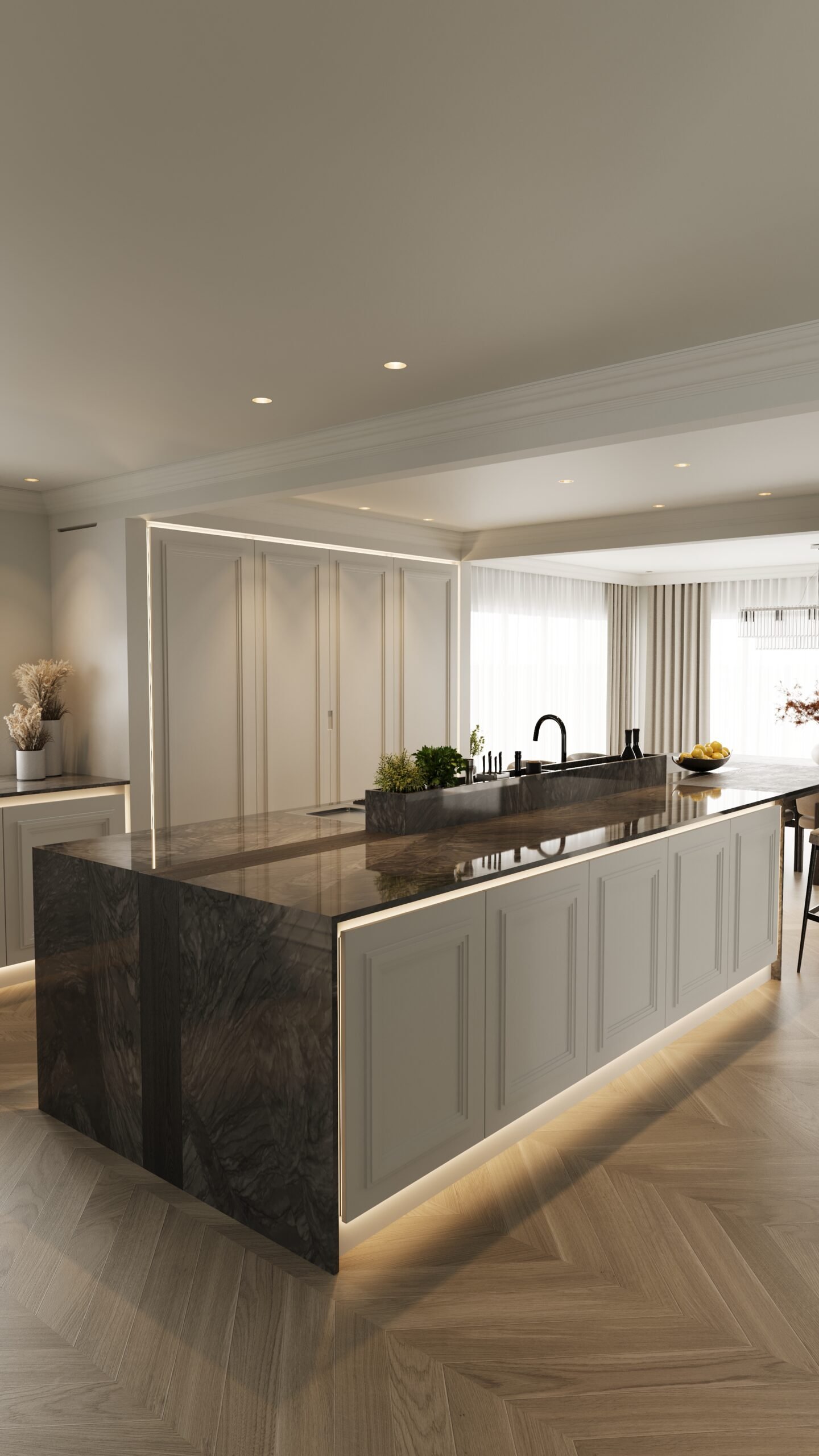 Stiligt - Modernt kök med en stor marmorö, inbyggd diskho, belysning under skåpen och minimalistisk inredning. Naturligt ljus kommer in genom skira gardiner på stora fönster.