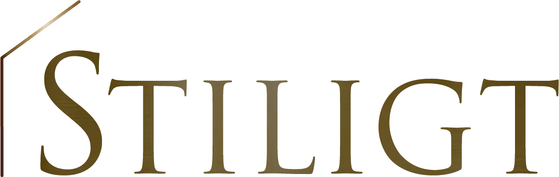 Stiligt - Bilden visar ordet "STILIGT" i stora, guldfärgade versaler med en tunn diagonal linje ovanför bokstaven "S".